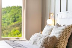 atelier-maison-casa-bonita-california-mountain-ranch-the-cliffs-mountain-park-marietta-sc-design-services-bedroom-detail-patterned-pillows-fur-throw-sconce-13