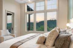atelier-maison-casa-bonita-california-mountain-ranch-the-cliffs-mountain-park-marietta-sc-design-services-primary-bedroom-dusk-large-windows-mountain-sunset-19